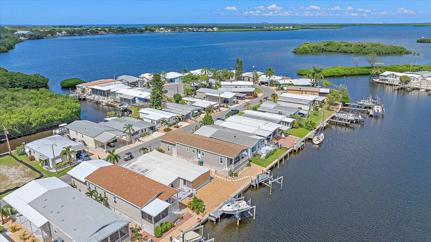 Aerial view over the canal basin and Terra Ceia Bay at 211 Bimini Drive, Tropic Isles, Palmetto, Florida