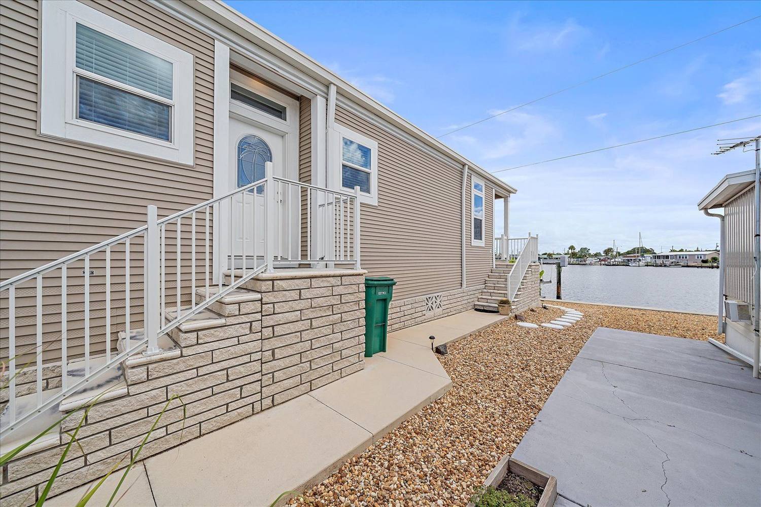 Front elevation and entry steps at 211 Bimini Drive