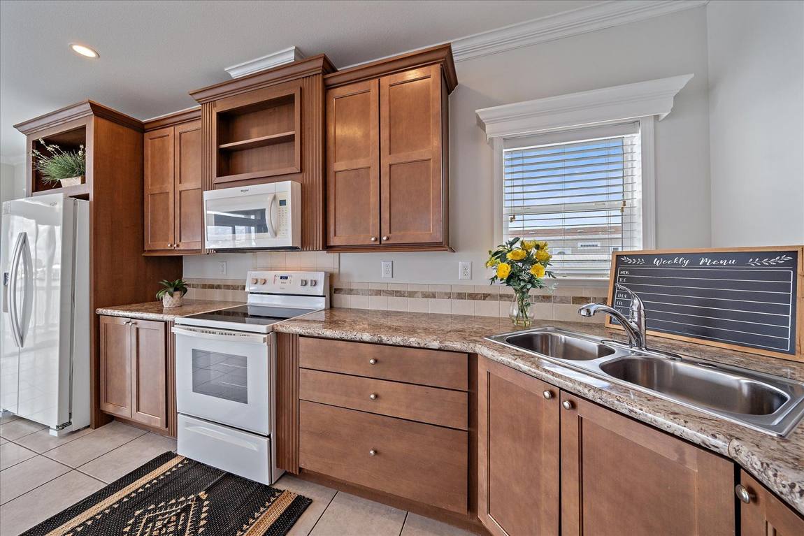 Kitchen with wood cabinetry and granite counters