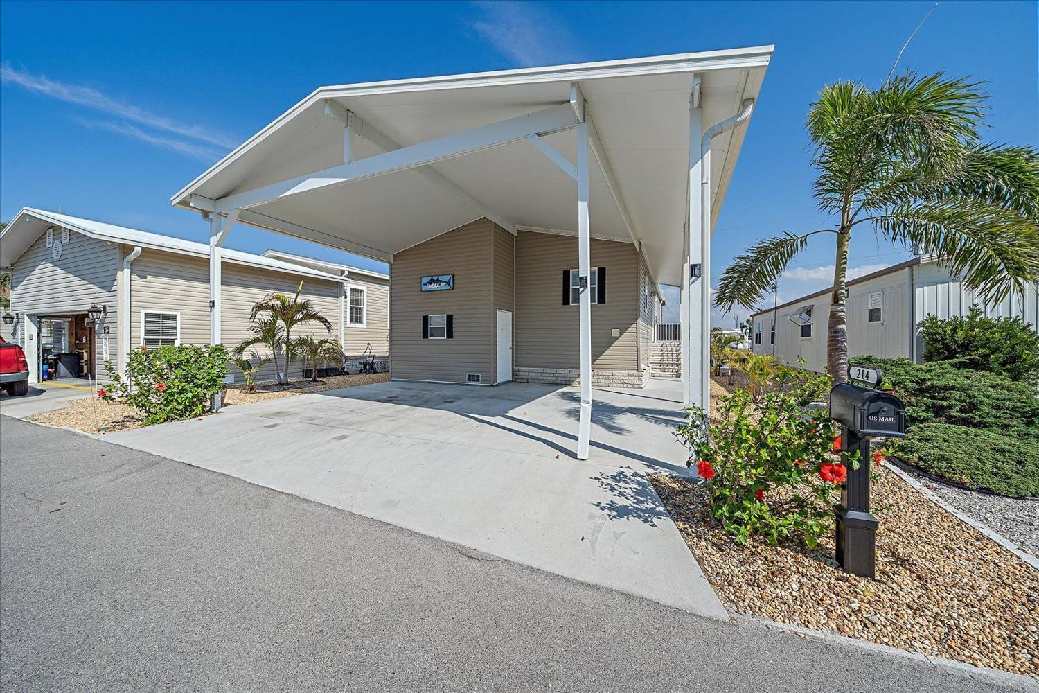 Front elevation and covered carport at 214 Bimini Drive