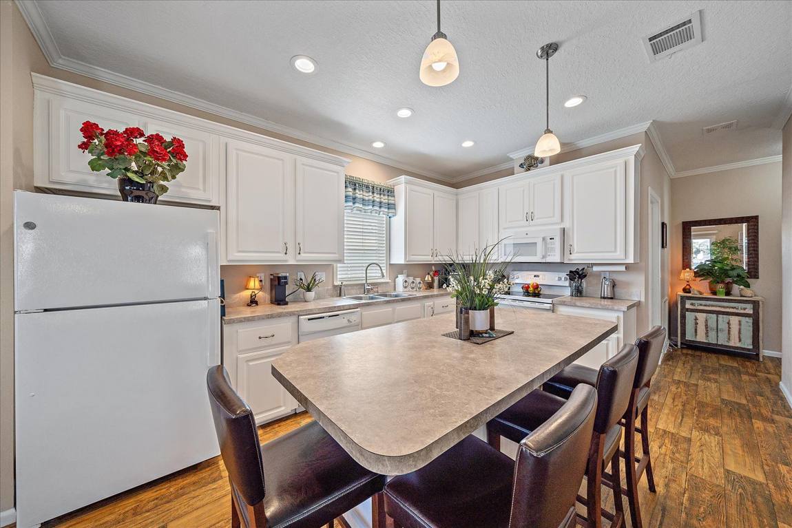 Kitchen with island seating and white cabinetry