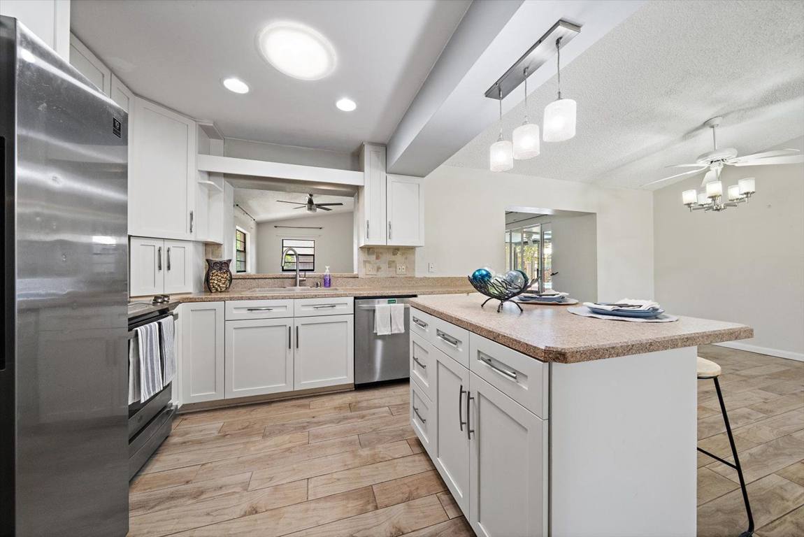 Updated kitchen with island and stainless appliances